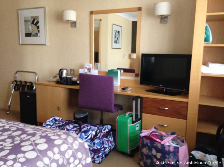 Photo of the layout of our accessible room at the Premier Inn, our many suitcases visible